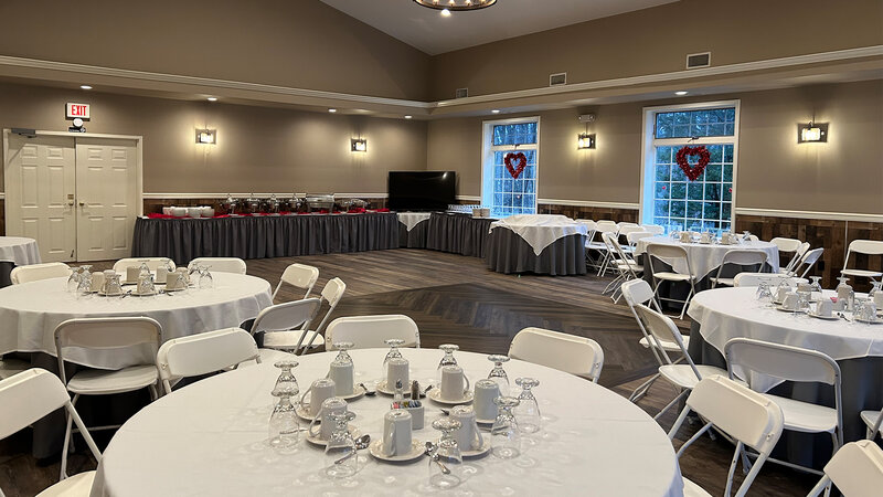 Banquet room with round tables and buffet table