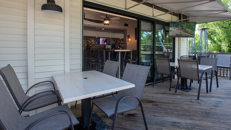 Patio dining area with view of interior bar area - The Village Inn - Gallery Photo 2 Patio dining area with view of interior bar area