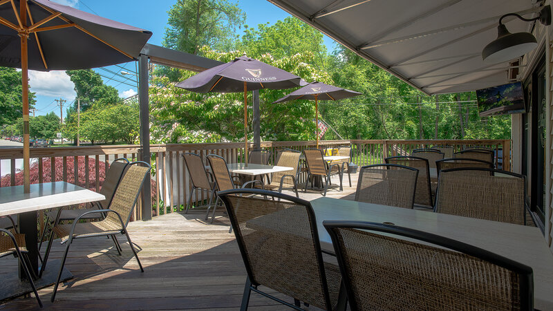 Patio dining area with tables - The Village Inn - Gallery Photo 1 Patio dining area with tables